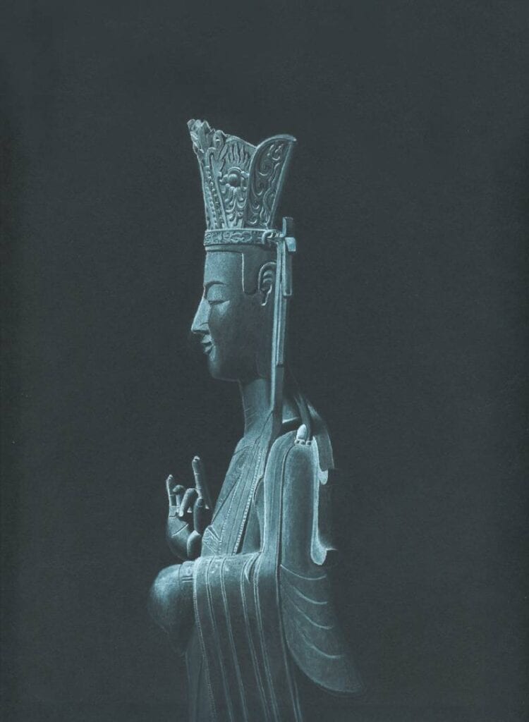 Elegant crowned bodhisattva statue in profile